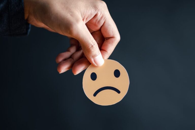 Are you driving customers away? Frownie face being held by a customer