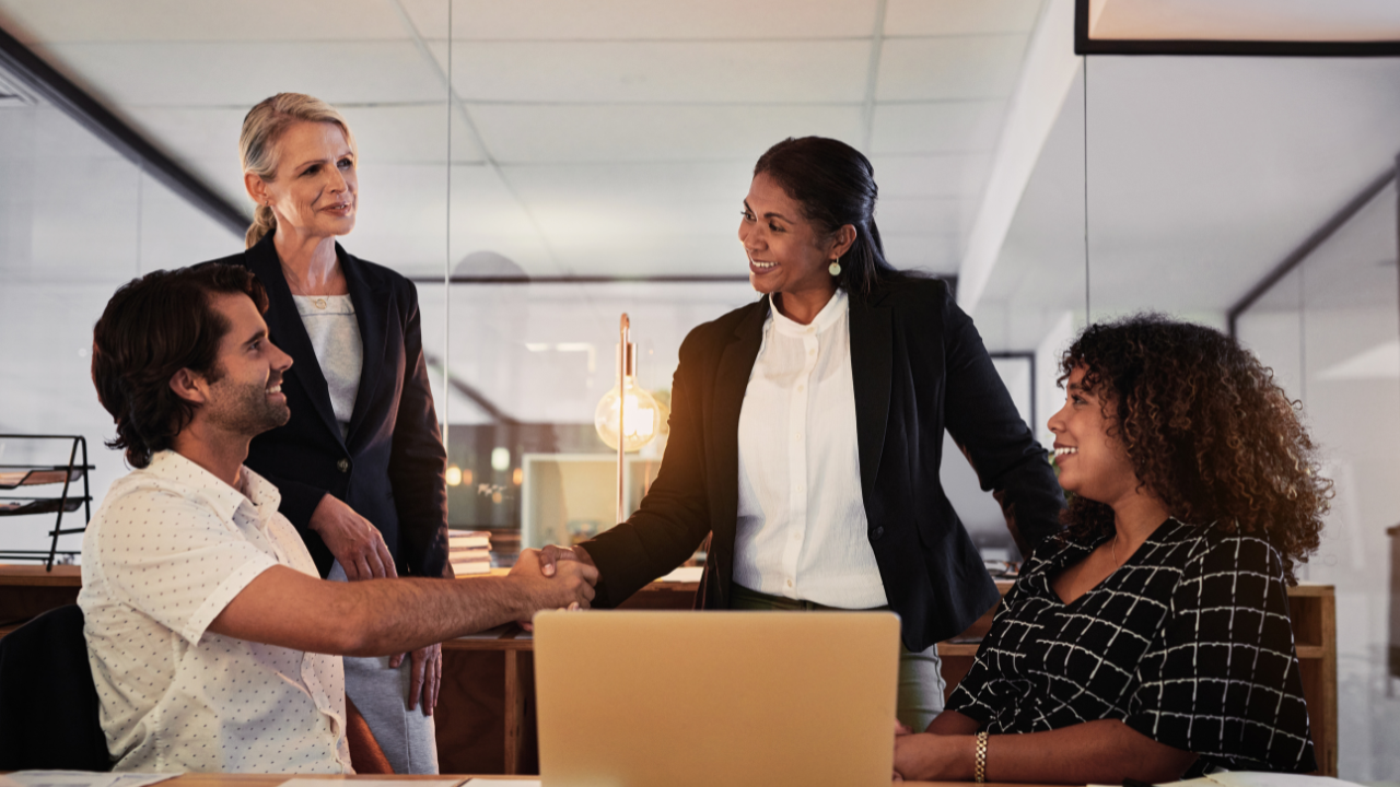 Client relationship a man and woman shake hands in a business setting